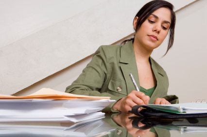 Businesswoman filling out paperwork